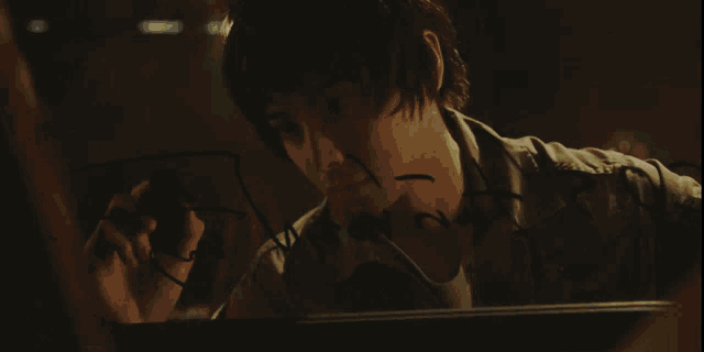 a man writing on a piece of paper that says ' i 'm sorry ' on it