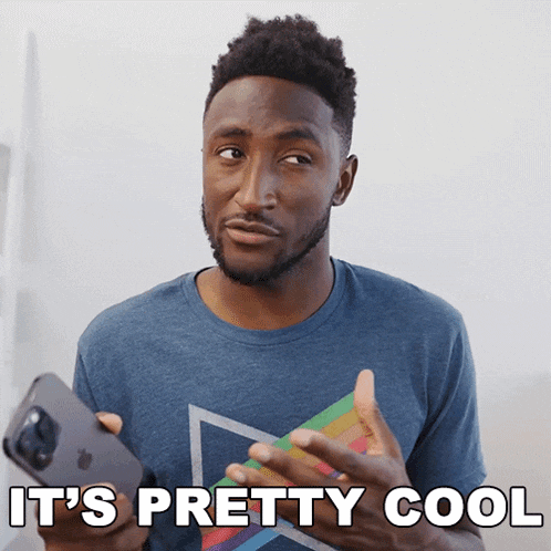 a man in a blue shirt is holding an apple phone and the words it 's pretty cool are above him