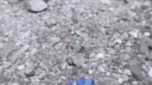 a person laying on the ground with a cell phone on their head