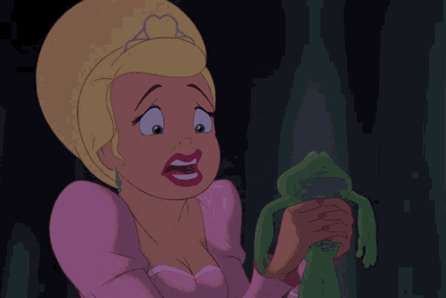 a woman in a pink dress is holding a green frog in her hands