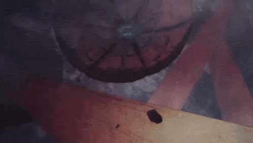 a close up of a piggy bank with smoke coming out of it in a dark room .