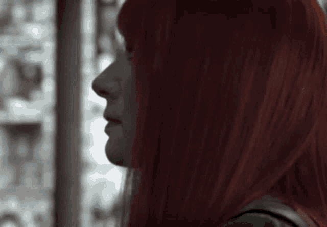 a close up of a woman with red hair