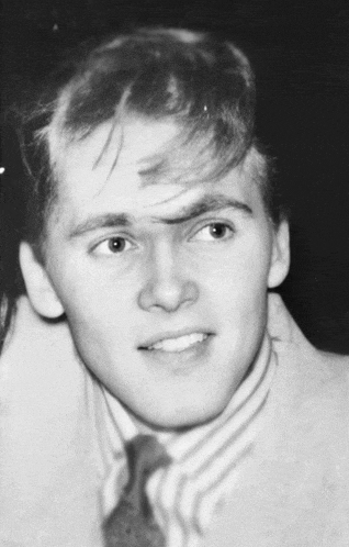 a black and white photo of a young man