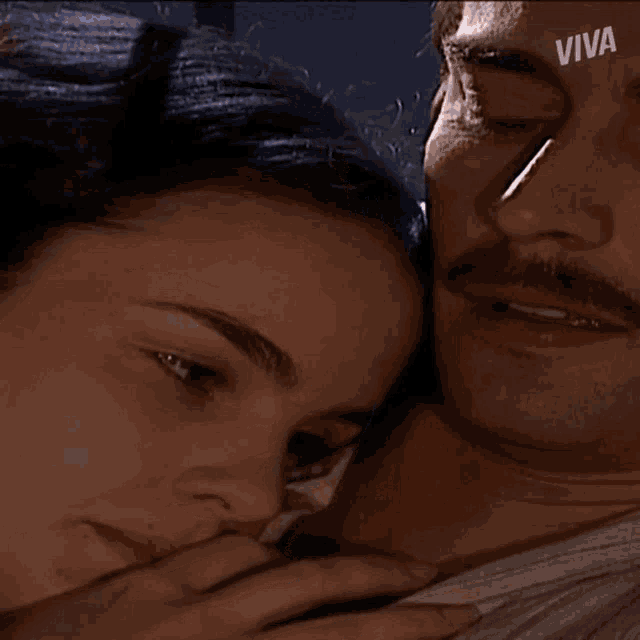 a close up of a man and a woman with the word viva on the bottom