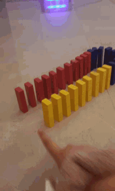 a person is playing a game of dominoes with a pink slipper on