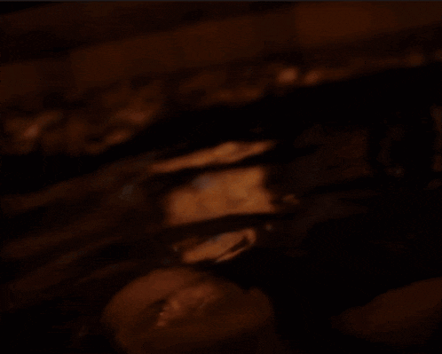 a woman is taking a bath with water coming out of her face