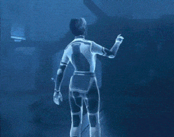 a woman in a futuristic suit is standing in a dark room with her hand outstretched .