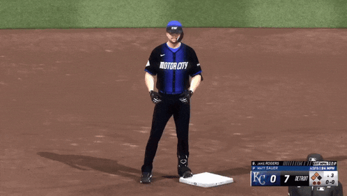 a baseball player wearing a motor city jersey stands on a base