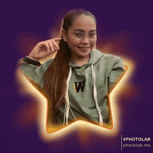 a woman wearing a green sweatshirt with the letter w on it