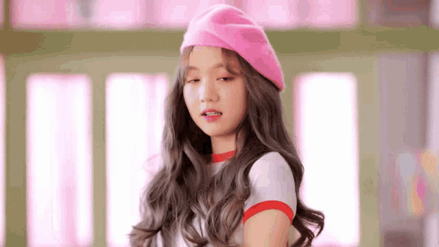 a young woman wearing a pink hat and a white shirt