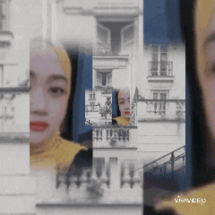 a woman wearing a hijab is surrounded by buildings