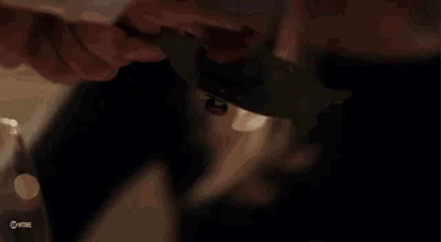 a close up of a woman smiling in a dark room