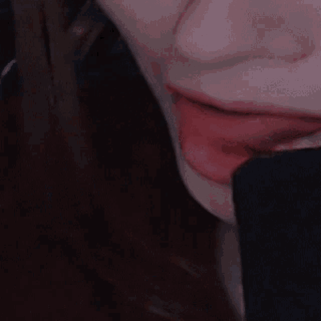 a close up of a woman 's mouth with red lipstick on