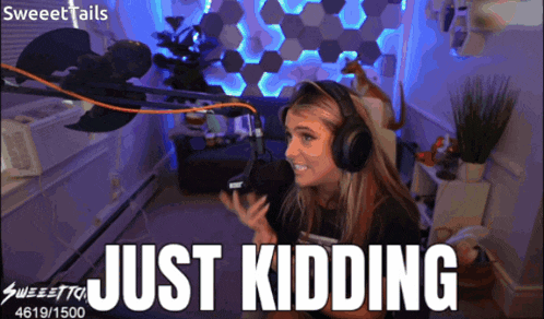 a woman wearing headphones is sitting in front of a microphone with the words just kidding above her