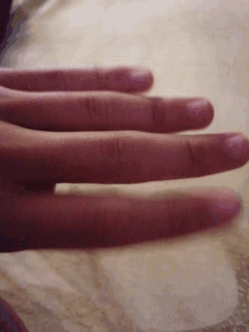 a close up of a person 's hand with three fingers extended