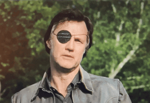 a man with a patch on his eye is wearing a leather jacket