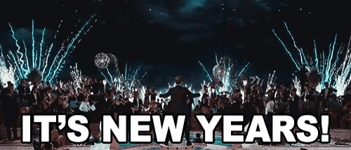 a sign that says it 's new years in front of a crowd of people