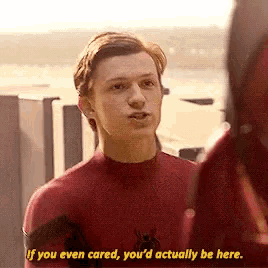 a man in a spider-man suit is talking to a man in a red suit .
