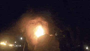 a person is holding a light in their hand