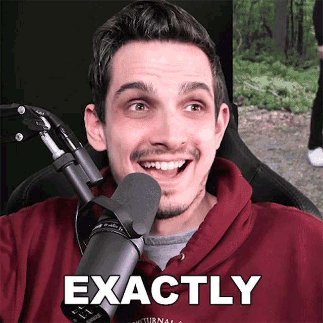 a man sitting in front of a microphone with the word exactly on the bottom