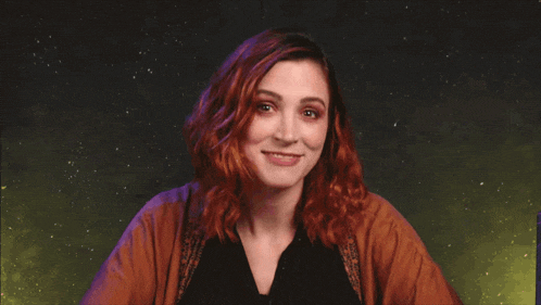 a woman with red hair is smiling in front of the words star trek