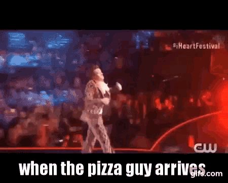 a man singing on a stage with the words when the pizza guy arrives on the bottom