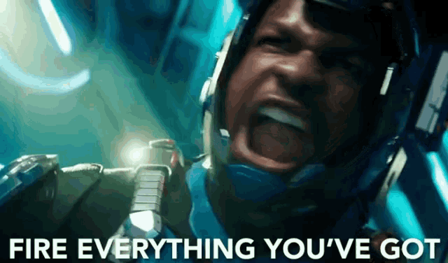 a man wearing a helmet is screaming with the words fire everything you 've got written below him