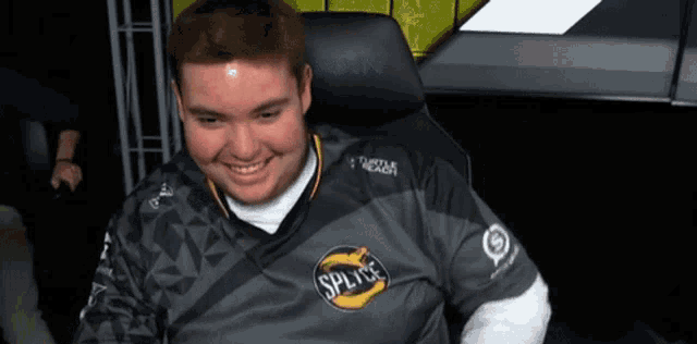 a man in a splitse shirt is smiling