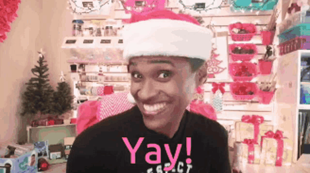 a man wearing a santa hat and a shirt that says " yay "