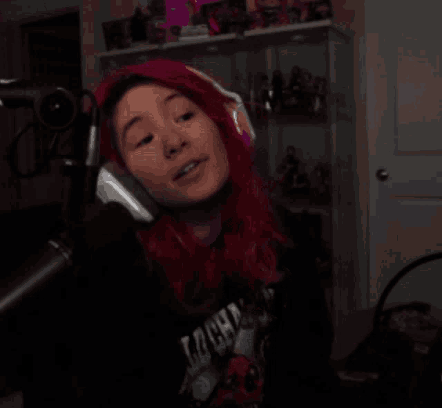 a woman with red hair is wearing headphones and a shirt that says ' cpu ' on it
