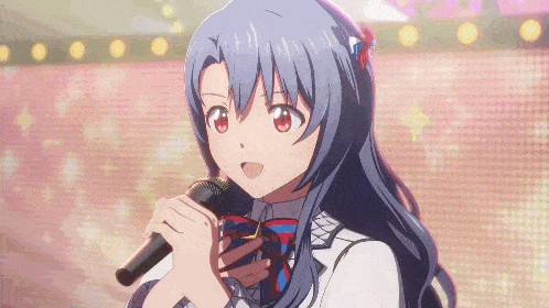 a girl with long blue hair is singing into a microphone in front of a pink backdrop