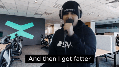 a man singing into a microphone with the words and then i got fatter