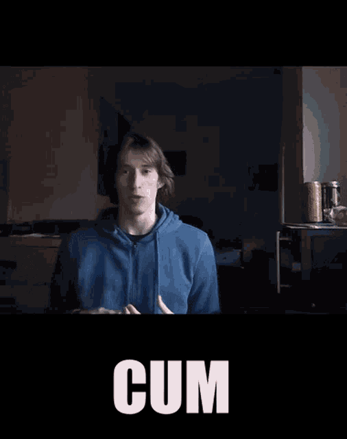 a man in a blue hoodie says cum in front of him