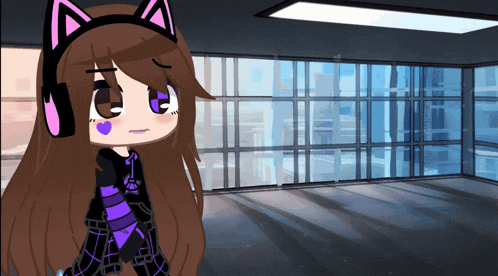 a girl wearing headphones and a cat ear headband stands in an empty room