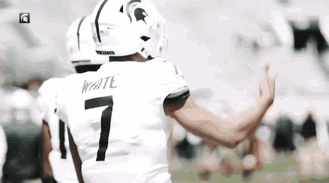 a man wearing a white jersey with the number 7 on it