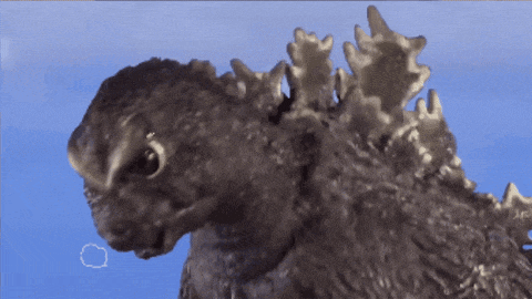 a close up of a monster 's head with a blue sky in the background