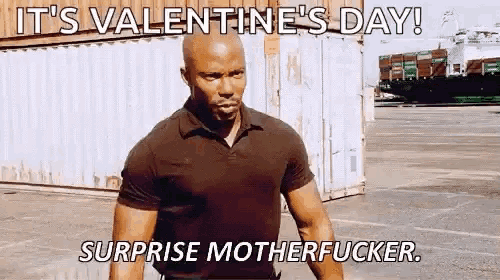 a man in a black shirt is standing in a parking lot and says it 's valentine 's day