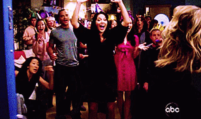 a group of people are dancing at a party with abc written on the bottom