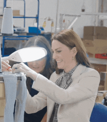 two women are looking at something under a light