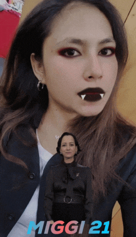 a picture of a woman with vampire teeth and the name miggi 21 on the bottom