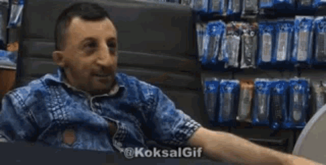 a man is giving a high five in a store while sitting in a chair .