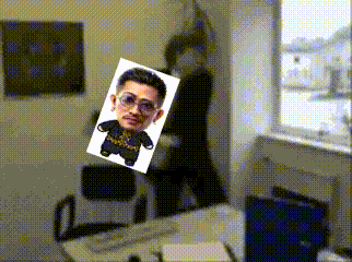 a picture of a man 's face is floating in the air above a desk