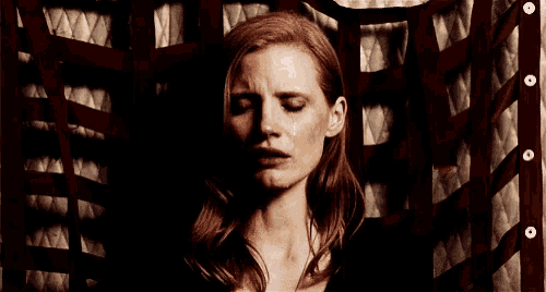 a woman with her eyes closed and a tear running down her cheek