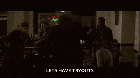 a close up of the joker 's face with the words `` lets have tryouts '' written below him .