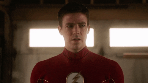 a man in a red superhero costume has a lightning bolt on his chest