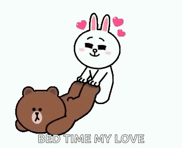 a brown bear and a white rabbit are laying on each other .