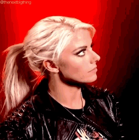 a woman with blonde hair and a ponytail is wearing a black leather jacket and a black t-shirt .
