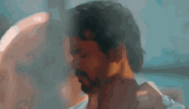 a man with a beard is standing in a room with smoke coming out of his hair .