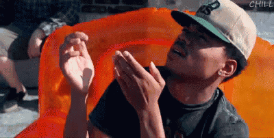 a man in a hat is sitting on an orange raft