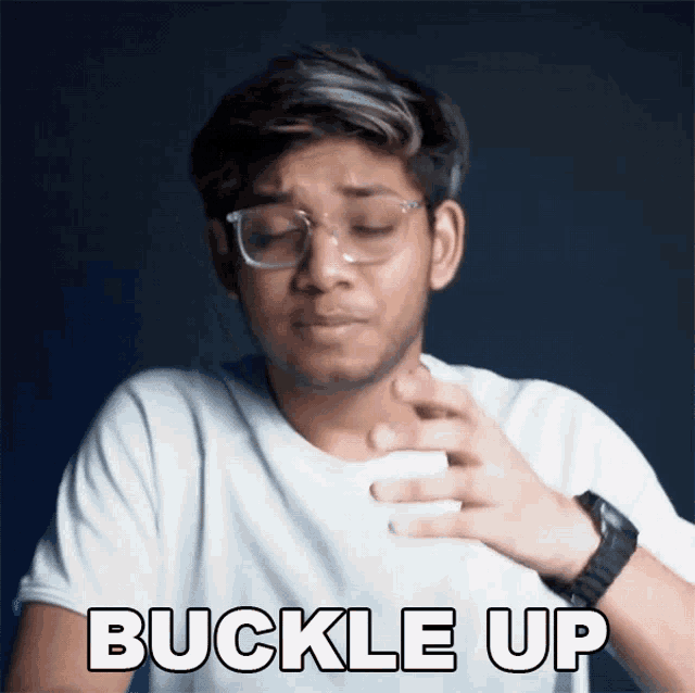 a young man wearing glasses and a white shirt says buckle up